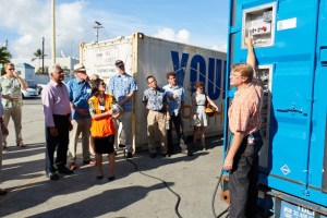Nami shows a group of employees how to operate the hydrogen generator