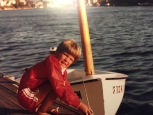 A young Dave Merritt ties a small dinghy to a dock.