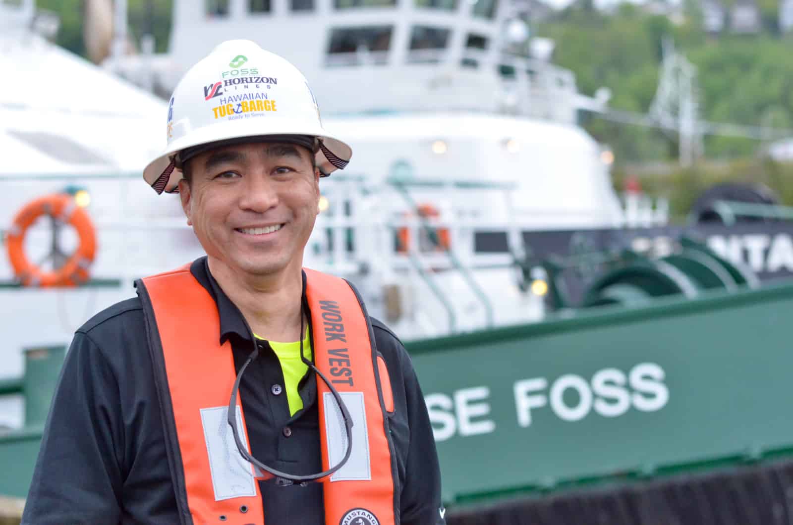 Lau smiles in front of a Foss tug.
