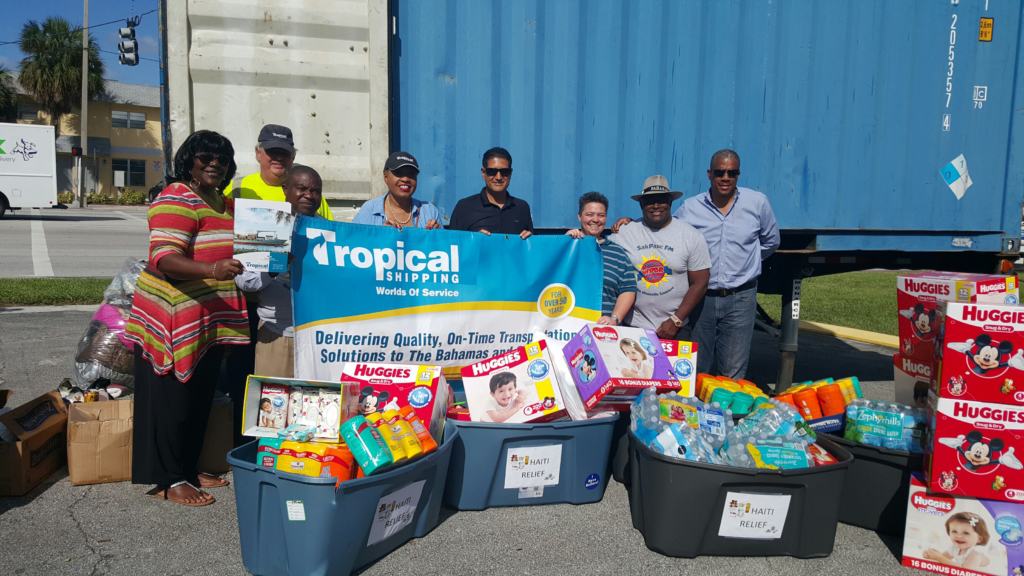 Nugent-Hill stands with Tropical employees with a load of supplies Haiti bound.
