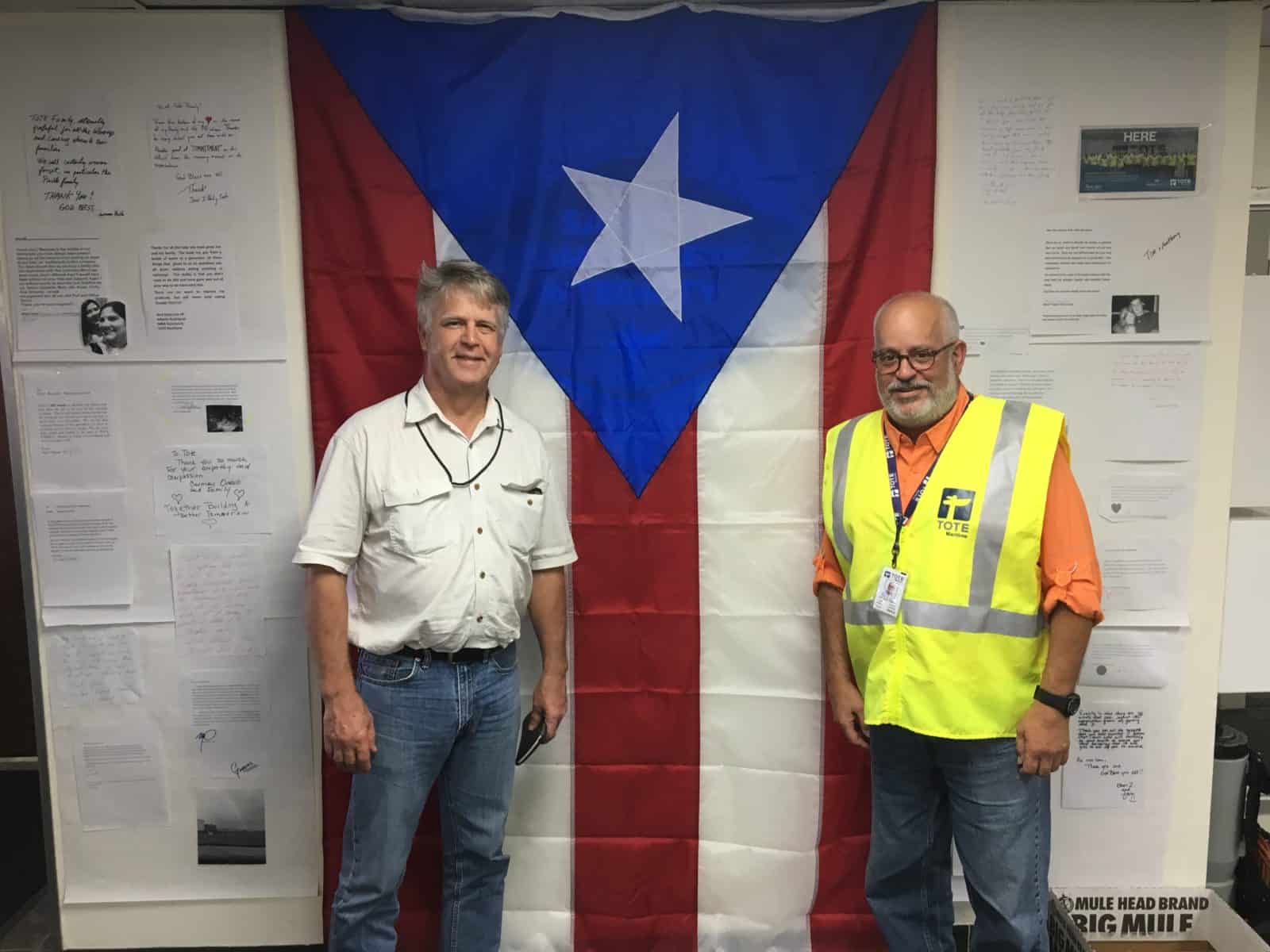 Wagoner poses in front of a Puerto Rican flag with TOTE VP.