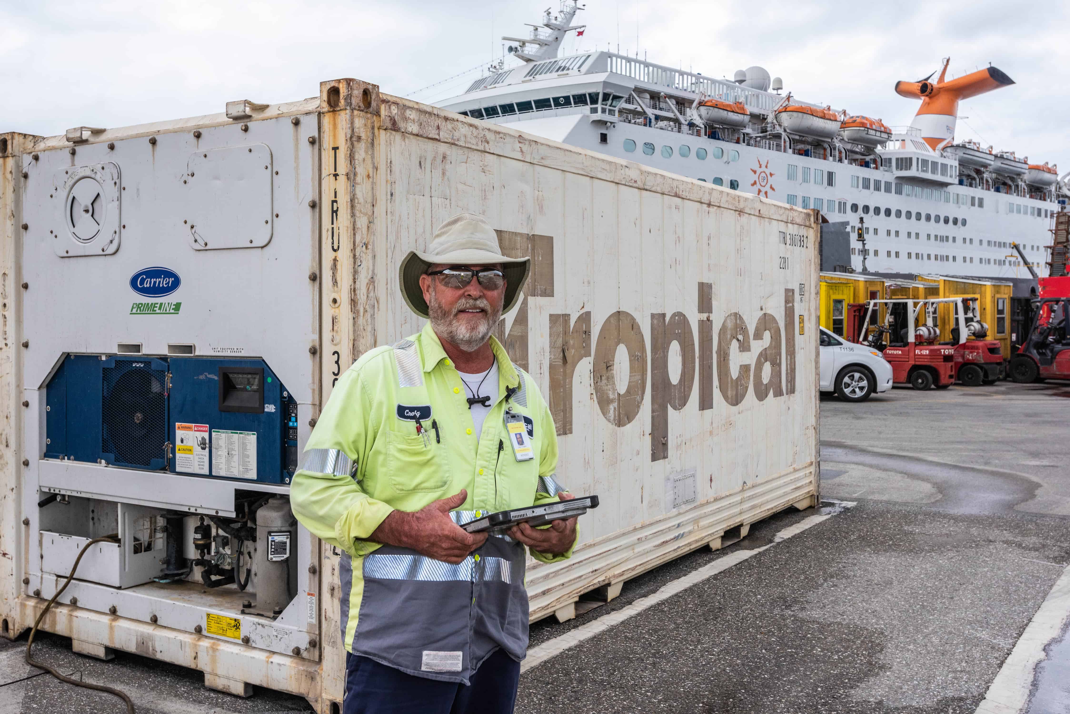 Coughlin poses in front of a Tropical shipping container, wearing a cowboy hat.