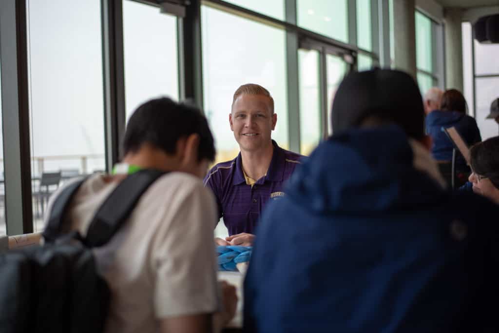 Dahlin is seen smiling while interacting with students.