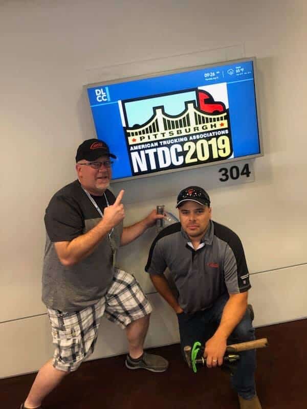 Hinkes and Welton pose in front of Pittsburgh's NTDC 2019 sign.