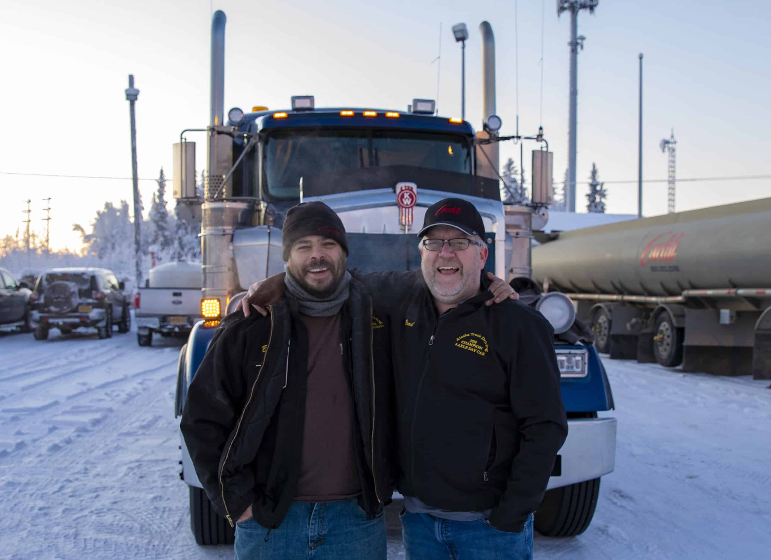 Michael and Jeremy pose in front of a Carlile truck.