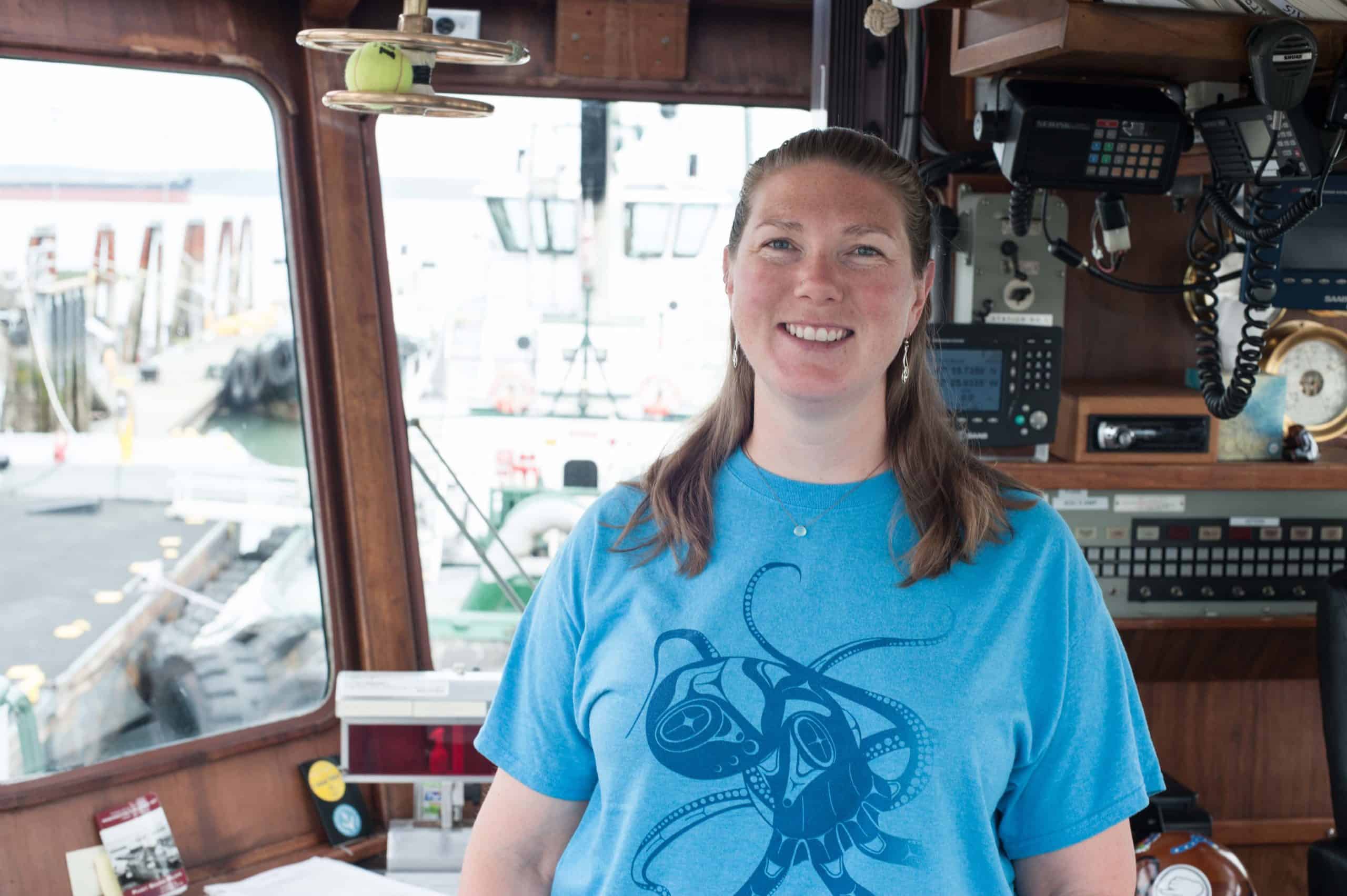 Katrina Anderson poses at the helm of a Foss tug.