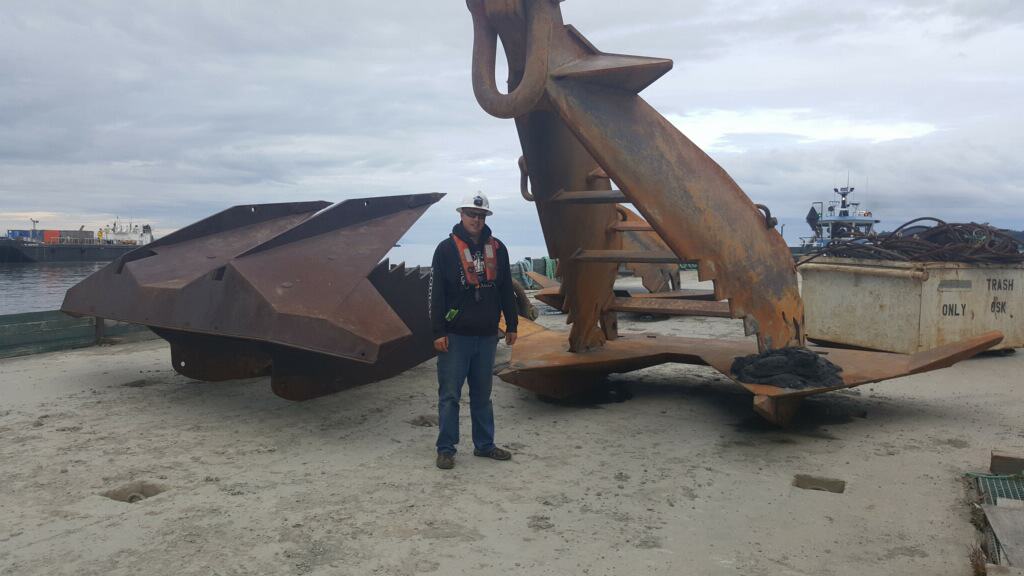 Justin poses in front of a massive anchor.