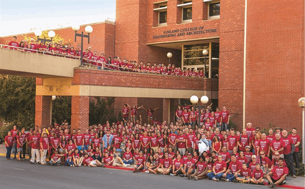 WSU students flood out the doors of the Voiland College of Engineering and Architecture posing for a group photo.