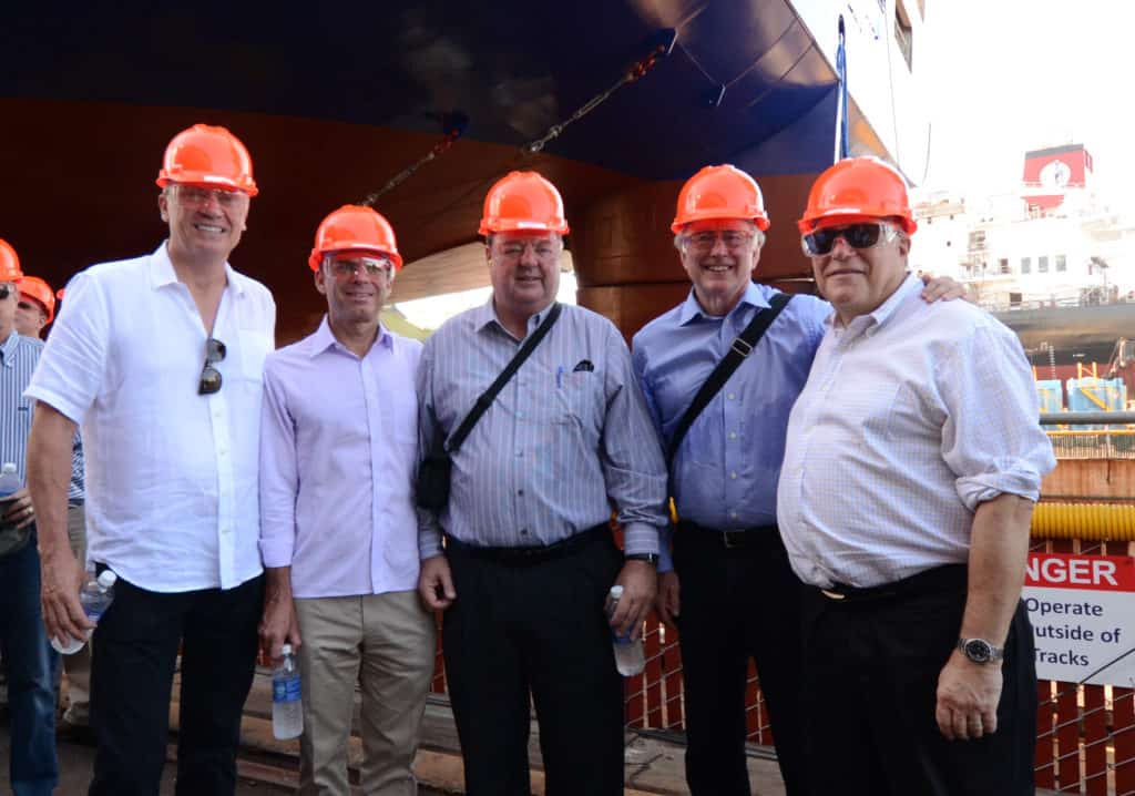 Voiland, center, poses with friends in front of the stern of the Perla del Caribe.