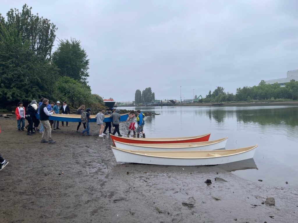 MHS canoes being carried out to the Duwamish river.