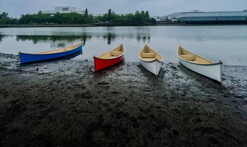 MHS canoes sit ready to be used at the edge of the Duwamish river.
